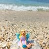 Handmade polymer clay fairy miniature holding a blue magic rock